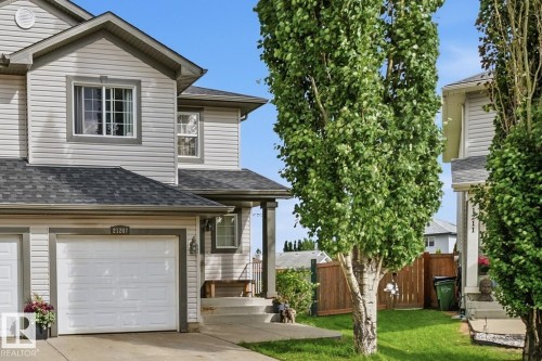 Two-story residence featuring light gray siding, dark gray trim, and a dark shingle roof - 21207 90Ave, Edmonton, AB 