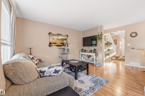 Open-concept living space with light wood-finish flooring - 21207 90Ave, Edmonton, AB 