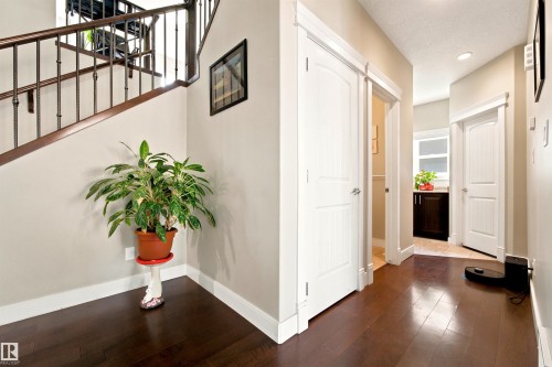 Rich wood-finish flooring extending from the entryway - 5110 Rue Eaglemont, Beaumont, AB 