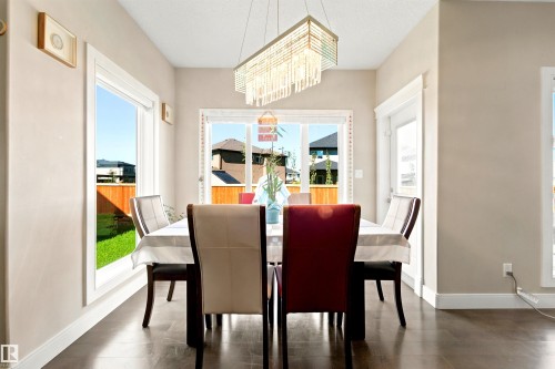 Dining area featuring dark wood-finish flooring and neutral wall tones - 5110 Rue Eaglemont, Beaumont, AB 