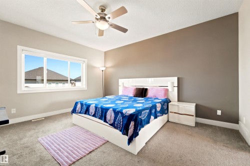 Spacious interior featuring a neutral color palette, recessed window, and ceiling fan with integrated lighting - 5110 Rue Eaglemont, Beaumont, AB 