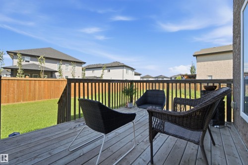 Spacious outdoor deck featuring weathered wood planks and a wooden railing - 5110 Rue Eaglemont, Beaumont, AB 
