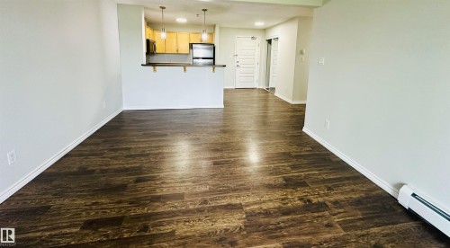 Spacious interior featuring wood-finish flooring throughout - 318 646 Mcallister Loop, Edmonton, AB 