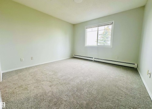 Spacious room featuring light gray carpeting and neutral wall paint - 318 646 Mcallister Loop, Edmonton, AB 