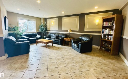 Spacious common area featuring neutral-toned tile flooring - 318 646 Mcallister Loop, Edmonton, AB 