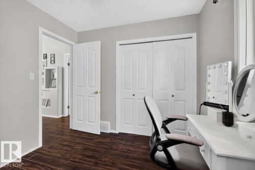 Room featuring wood-finish flooring, light grey walls, and white trim - 3907 33 Street, Edmonton, AB 