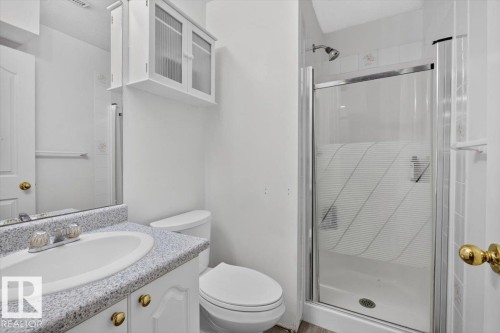 White single vanity with an integrated sink and a speckled countertop - 3907 33 Street, Edmonton, AB 