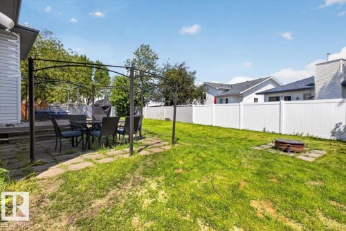 Expansive outdoor space featuring a large lawn area and a white privacy fence - 3907 33 Street, Edmonton, AB 