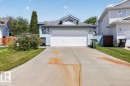 Light blue exterior siding with a front-facing garage and a concrete driveway - 3907 33 Street, Edmonton, AB 