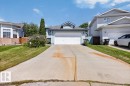 Light blue exterior siding with white trim, a large attached two-car garage, and a concrete driveway - 3907 33 Street, Edmonton, AB 