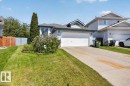 Property exterior featuring light blue siding, an attached two-car garage, and a concrete driveway - 3907 33 Street, Edmonton, AB 