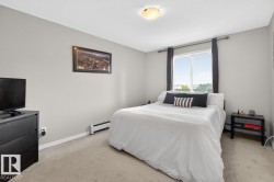 Carpeted room featuring light gray walls, a window with dark curtain rods, and a flush mount ceiling light - 