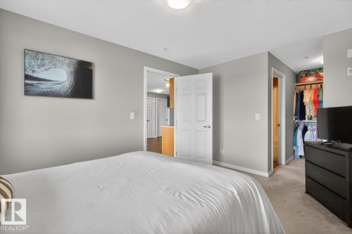 Carpeted sleeping area with light grey wall paint - 320 5005 165 Avenue, Edmonton, AB - Indoor Photo Showing Bedroom