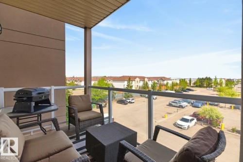 Private balcony featuring clear glass railings and a durable overhead soffit - 320 5005 165 Avenue, Edmonton, AB - Outdoor With Balcony With Exterior