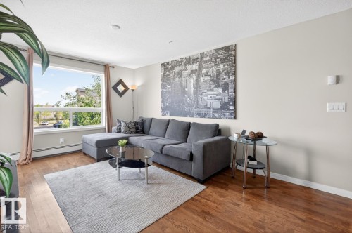 Expansive window providing ample natural light - 320 5005 165 Avenue, Edmonton, AB - Indoor Photo Showing Living Room