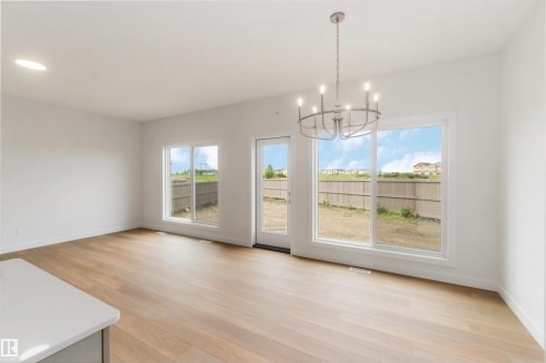 Open-concept living space with light wood-finish flooring - 19360 29 Avenue, Edmonton, AB 