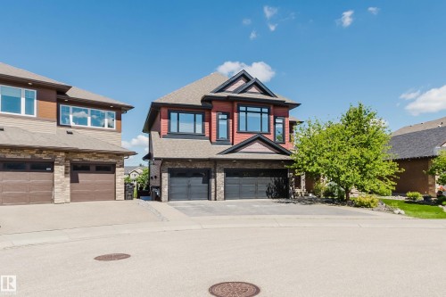 Contemporary residence featuring a red siding and stone facade - 3438 West Landing Landing, Edmonton, AB 