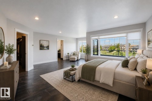Spacious room featuring dark wood-finish flooring, recessed lighting, and expansive windows - 3438 West Landing Landing, Edmonton, AB 