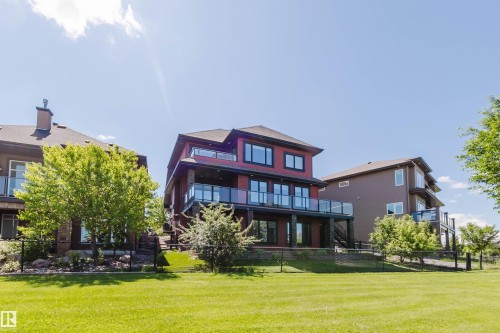 Multi-story residential property featuring a red exterior with multiple balconies - 3438 West Landing Landing, Edmonton, AB 