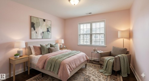 Bedroom featuring a large window with gridded panes, dark wood-finish flooring, and a ceiling-mounted light fixture - 3438 West Landing Landing, Edmonton, AB 