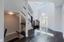 Bright entryway featuring a white paneled door with sidelights, transom windows, and dark tile flooring - 3438 West Landing Landing, Edmonton, AB 