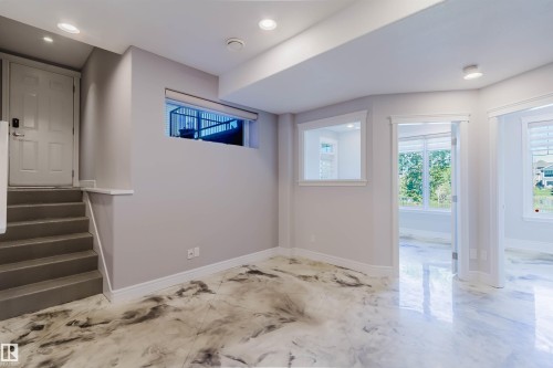 Spacious open area featuring distinctive high-gloss flooring, recessed lighting, and multiple windows providing natural illumination - 3438 West Landing Landing, Edmonton, AB 