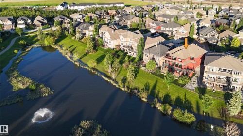 Red multi-story residence featuring multiple balconies and a sloped roof - 3438 West Landing Landing, Edmonton, AB 
