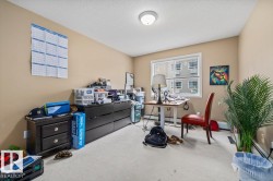 Carpeted room featuring a window with white trim, a flush-mount ceiling light fixture, and beige wall paint - 