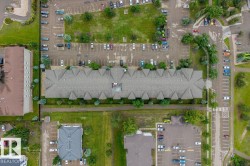 Multi-unit property with a prominent gray shingle roof, featuring multiple gables - 
