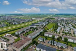 Aerial perspective showcasing a developed residential area with multiple apartment and townhome complexes - 