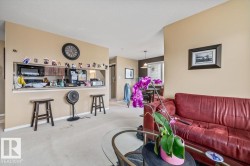Kitchen pass-through window with wooden cabinetry, upper microwave, and counter space - 