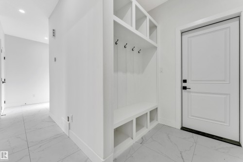 Built-in hall tree featuring upper cubbies, coat hooks, and lower storage compartments - 4409 35 Street, Beaumont, AB - Indoor Photo Showing Other Room