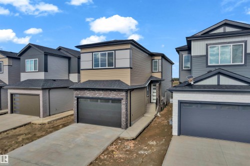 Contemporary multi-story residence featuring a tan and gray exterior with dark trim - 4409 35 Street, Beaumont, AB - Outdoor