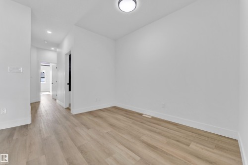Bright interior space featuring light wood-finish flooring - 4409 35 Street, Beaumont, AB - Indoor Photo Showing Other Room