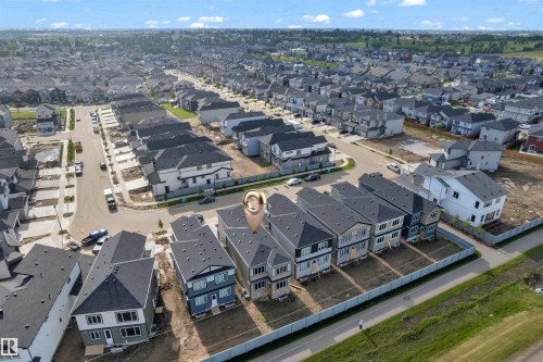 Expansive aerial perspective showcasing a residential community with a variety of detached and attached homes - 4409 35 Street, Beaumont, AB - Outdoor With View