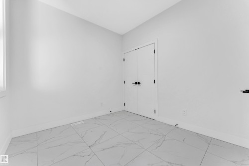 White tile flooring with subtle gray veining - 4409 35 Street, Beaumont, AB - Indoor Photo Showing Other Room