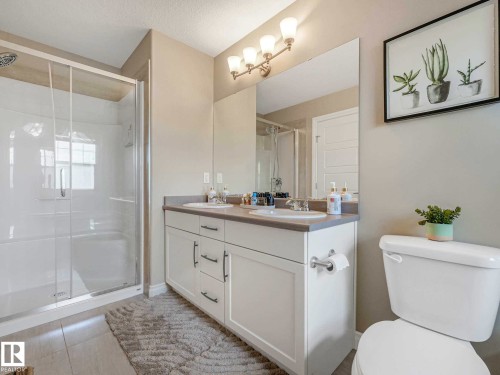 Bathroom featuring a glass-enclosed shower, a dual vanity sinks, - 162 Kirpatrick Way, Leduc, AB 