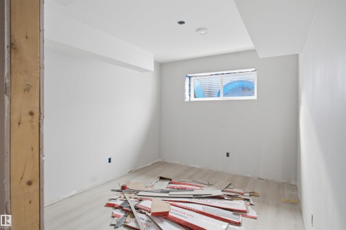 Room with a window well, recessed lighting, and light wood-finish flooring - 1222 Podersky Wynd, Edmonton, AB 
