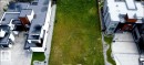 Expansive lot featuring a green space, bordered by contemporary properties with flat roofs and modern architectural lines - 31 Windermere Drive, Edmonton, AB 