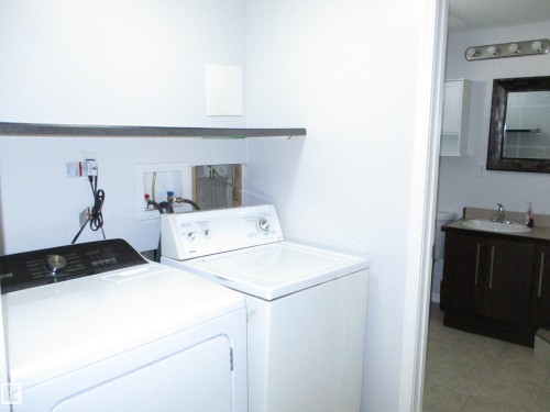 Laundry room with counter and cabinet space. - 10946 165 Street Nw, Edmonton, AB 