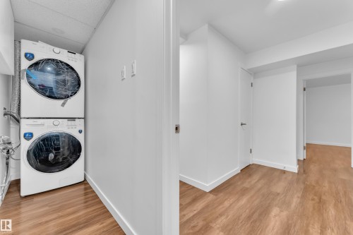 Dedicated laundry area featuring a stacked washer and dryer unit - 8104 135 Avenue, Edmonton, AB 