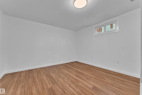 Neutral white walls complement wood-finish flooring - 8104 135 Avenue, Edmonton, AB 