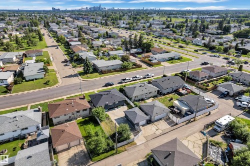Aerial perspective of a residential neighborhood with a distant cityscape - 8104 135 Avenue, Edmonton, AB 