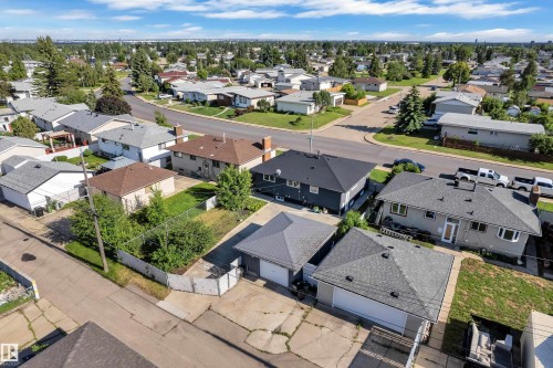 Aerial perspective showcasing a residential neighborhood with a mix of single-story and two-story homes - 8104 135 Avenue, Edmonton, AB 