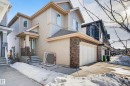 The property features a two-story exterior with siding and stone accents, a covered front entrance, and an attached garage - 2317 158A Street, Edmonton, AB 
