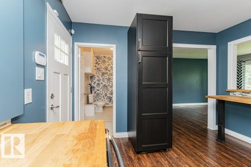 Rich wood-finish flooring complements the blue-painted walls - 13411 140 Street, Edmonton, AB 