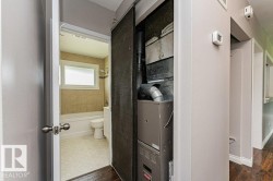 Bathroom featuring a white bathtub, toilet, and a window with privacy glass - 