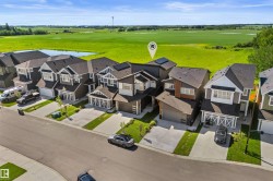 Modern two-story home featuring a dark gray and white exterior with multiple rooflines - 