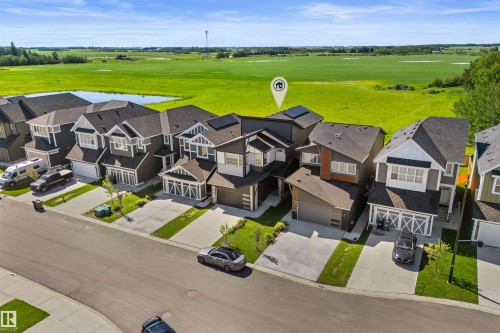 Modern two-story home featuring a dark gray and white exterior with multiple rooflines - 19 Sturtz Place, Leduc, AB 