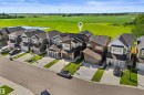 Modern two-story home featuring a dark gray and white exterior with multiple rooflines - 19 Sturtz Place, Leduc, AB 